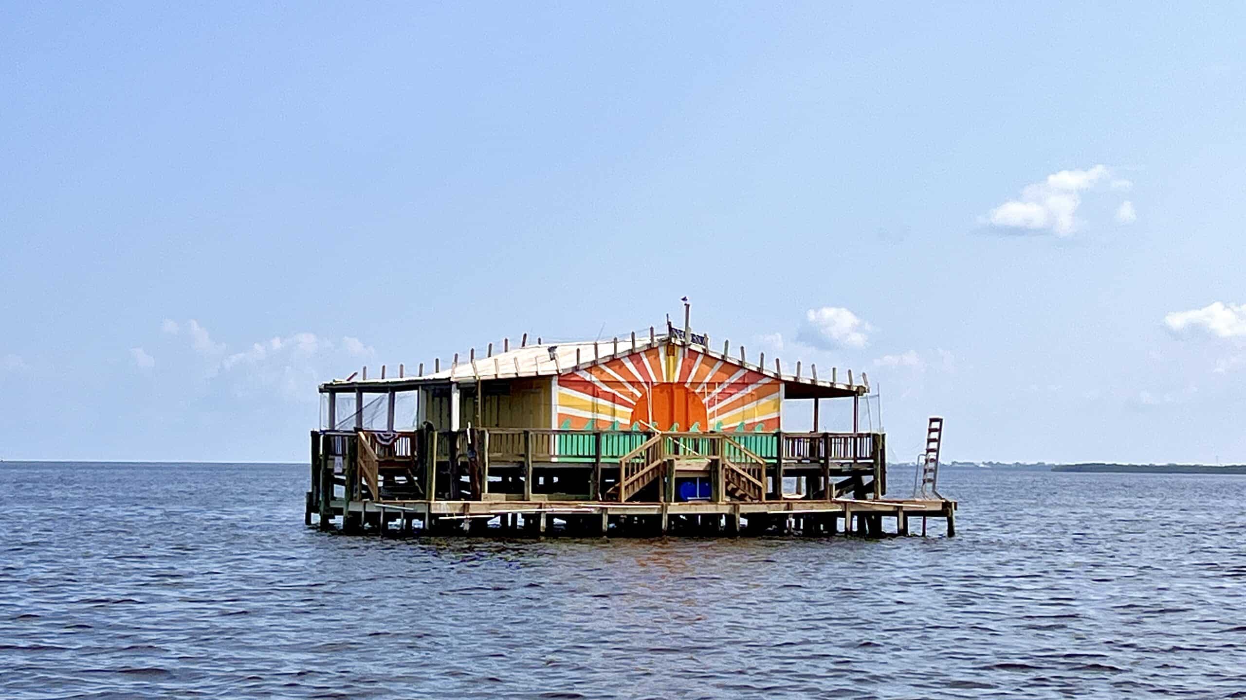 A freshly painted stilt house in the Gulf of Mexico.