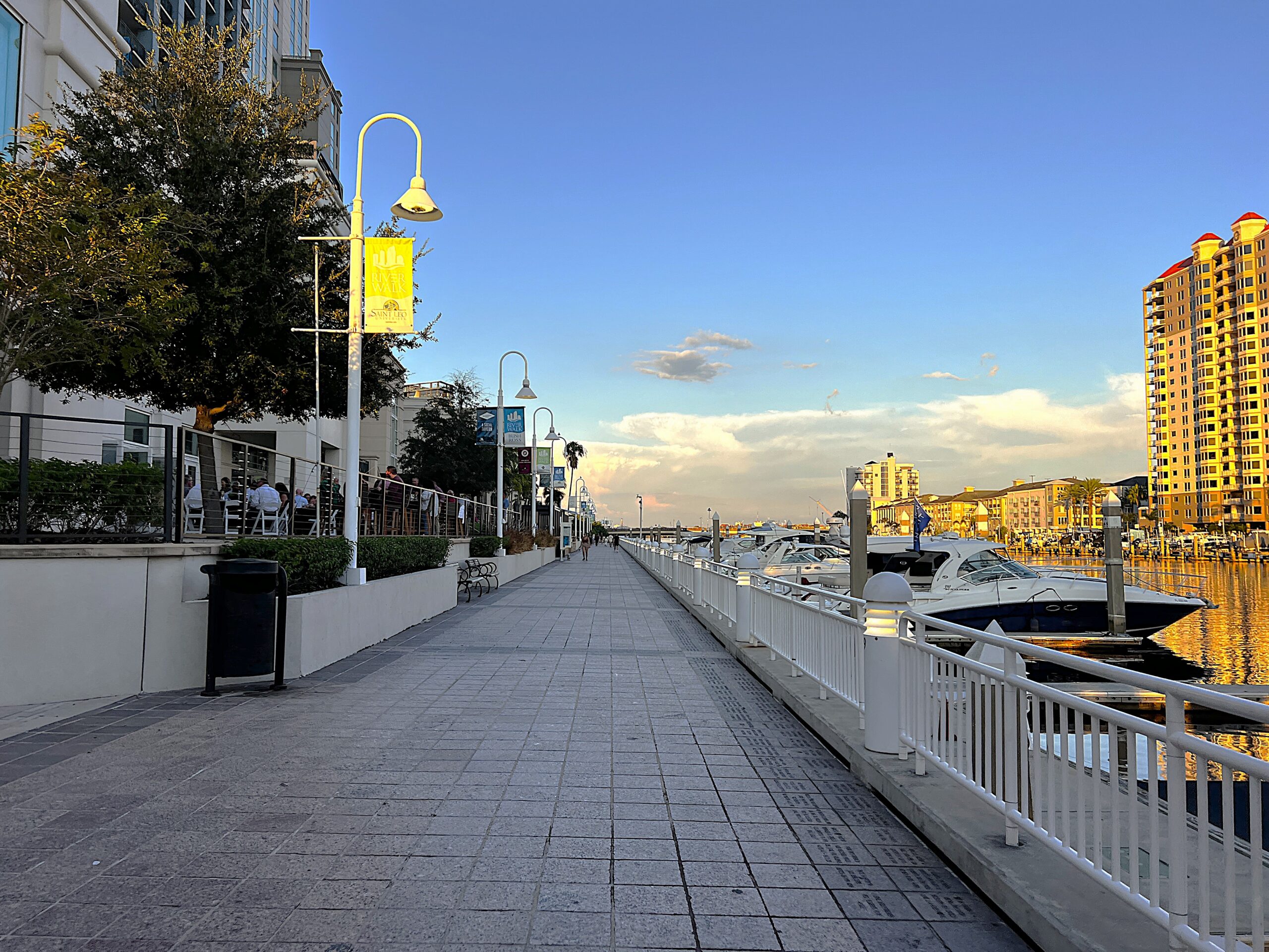 A look down the Tampa Riverwalk at sunset.